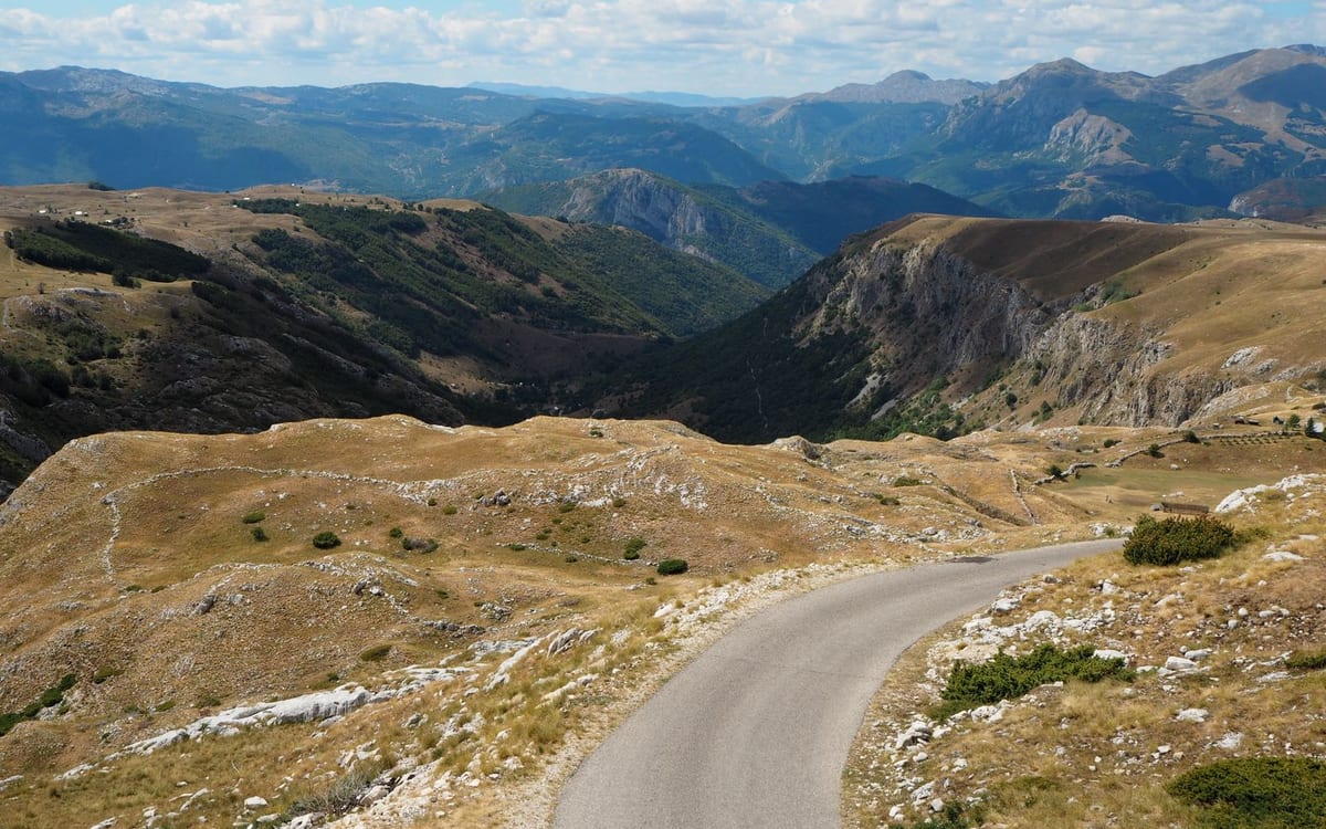 A scenic mountain road winding through the Montenegrin highlands